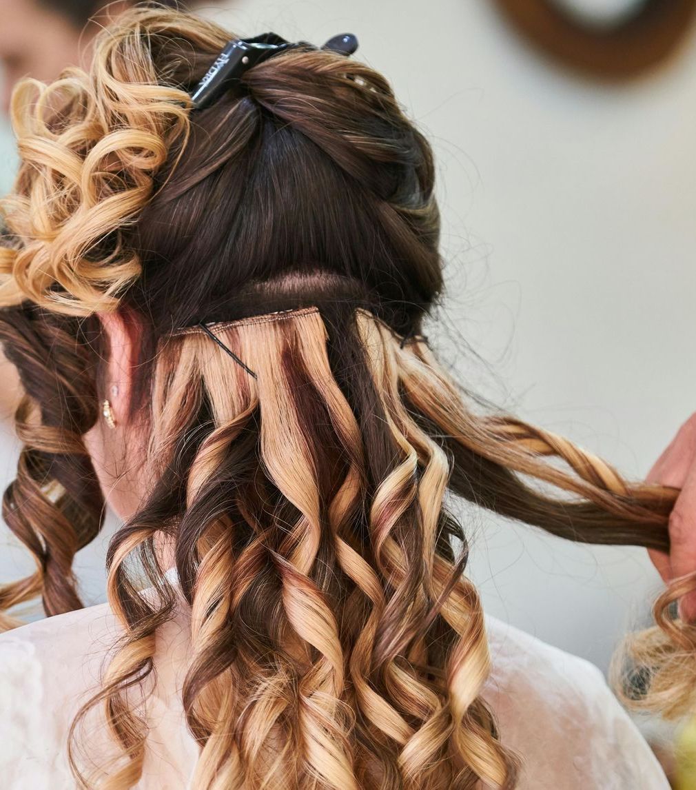 A woman is getting her hairstyle done by a hairdresser in Baytown, TX.